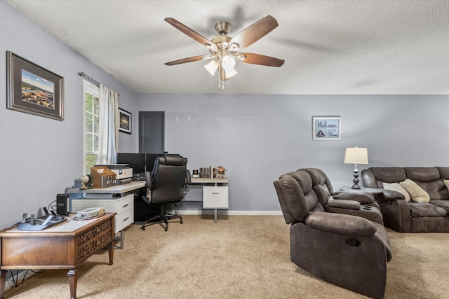 office with a textured ceiling, ceiling fan, and light colored carpet