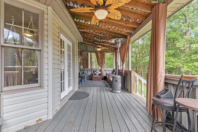 wooden deck featuring ceiling fan