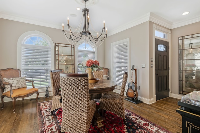 dining area with crown molding, dark wood-type flooring, and an inviting chandelier