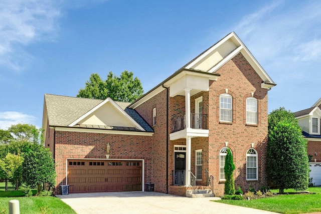 front of property featuring a balcony and a garage