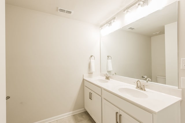 bathroom with tile patterned floors, vanity, and toilet