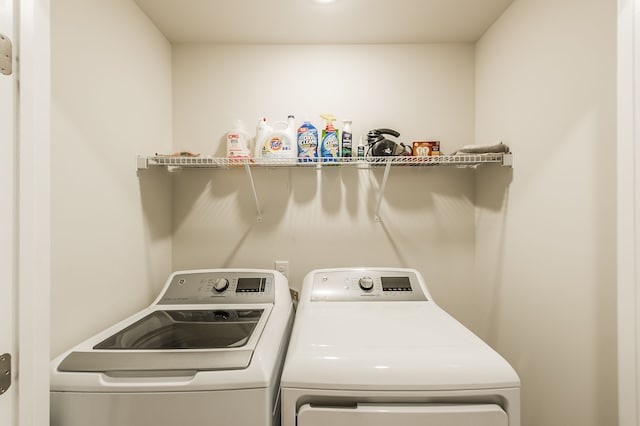 clothes washing area featuring separate washer and dryer