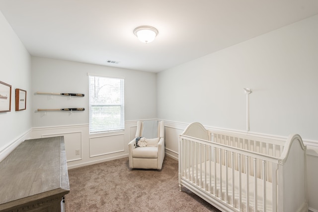 carpeted bedroom with a nursery area