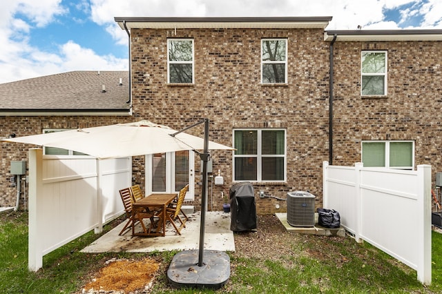 back of house with a patio area and central AC