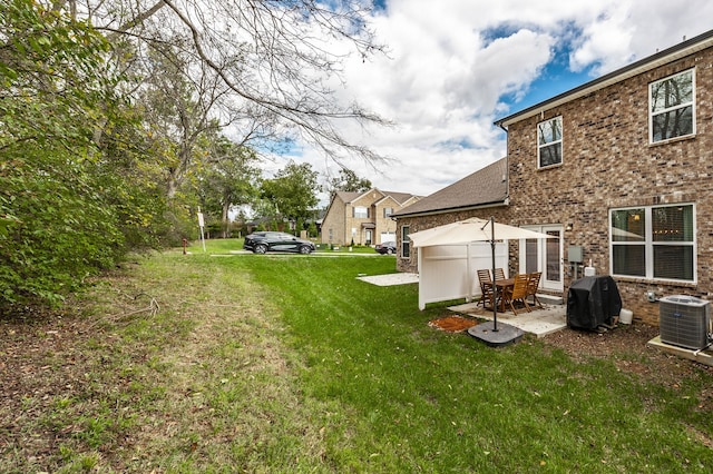 view of yard featuring central AC unit, a gazebo, and a patio area