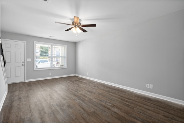 unfurnished room featuring ceiling fan and dark wood-type flooring