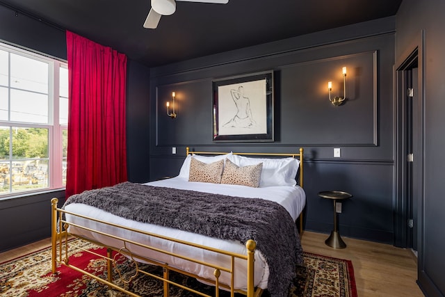 bedroom with wood-type flooring and ceiling fan