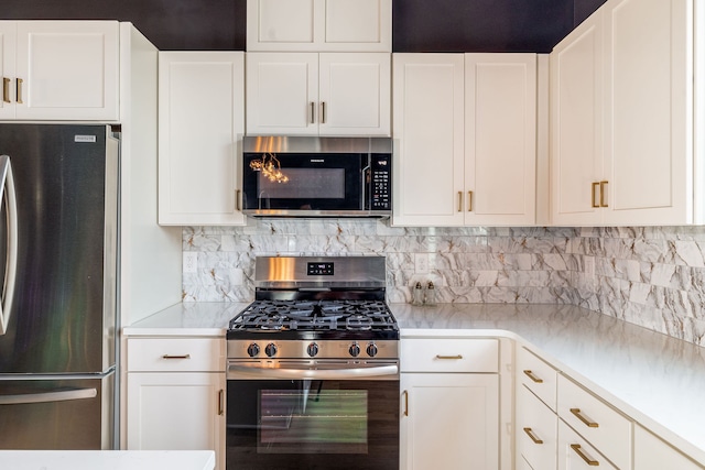 kitchen featuring appliances with stainless steel finishes, backsplash, and white cabinetry