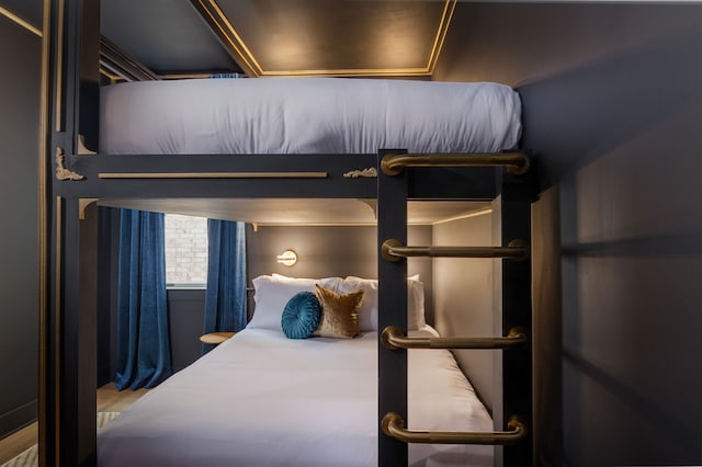 bedroom featuring wood-type flooring and crown molding