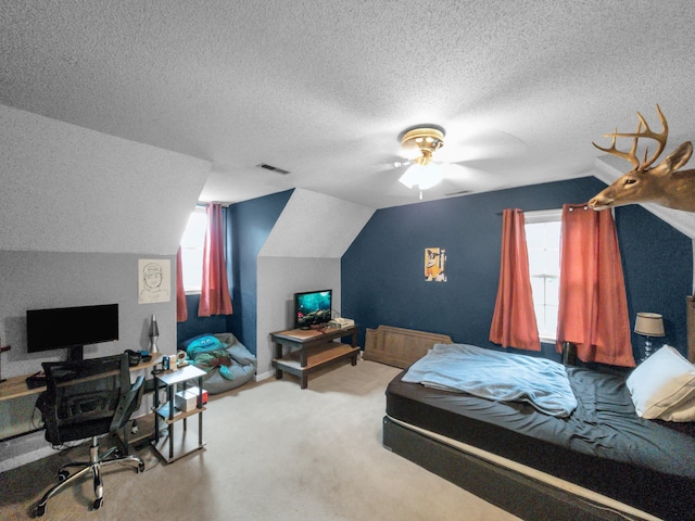 carpeted bedroom with ceiling fan, a textured ceiling, and vaulted ceiling