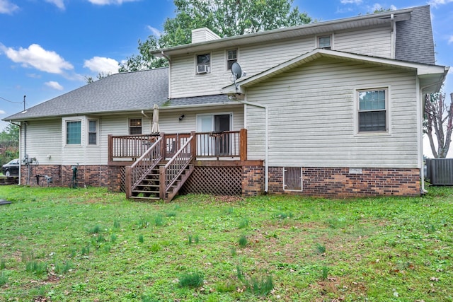 back of house with a deck, a yard, and central AC