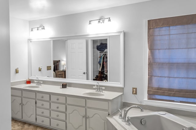 bathroom with vanity and a tub