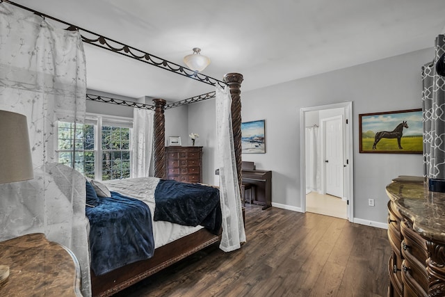 bedroom with dark hardwood / wood-style floors