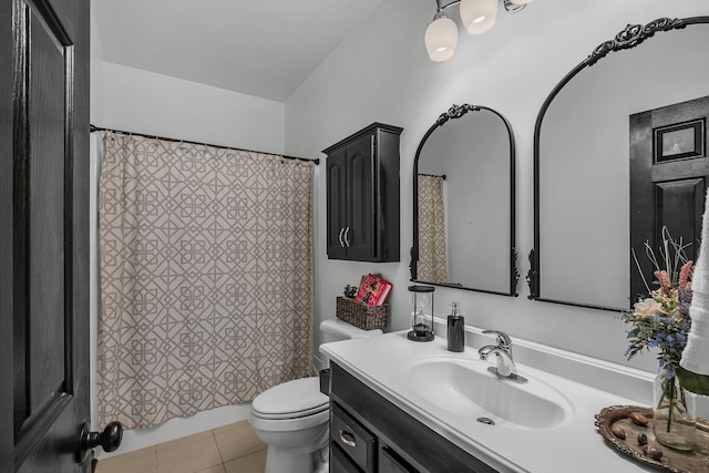 bathroom with tile patterned flooring, vanity, and toilet