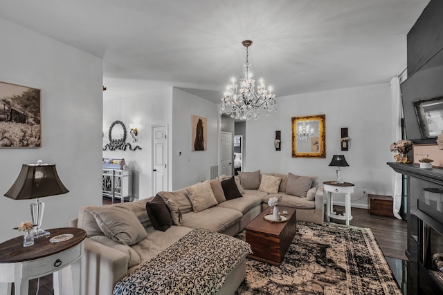 living room with a chandelier and dark wood-type flooring