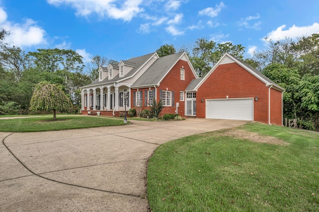 new england style home with a front yard and a garage