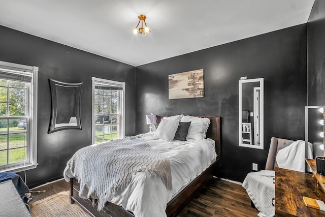 bedroom with dark hardwood / wood-style floors