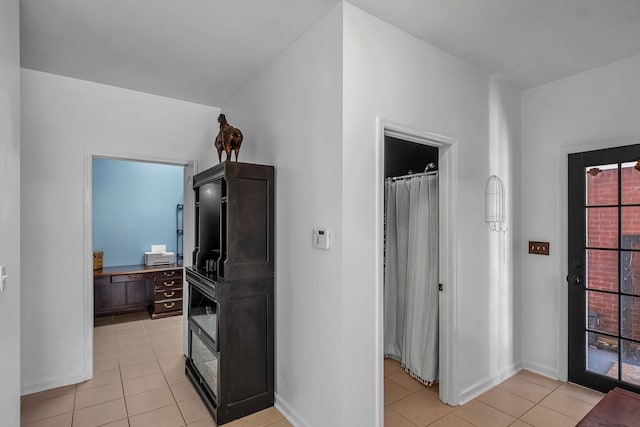 hall with light tile patterned floors