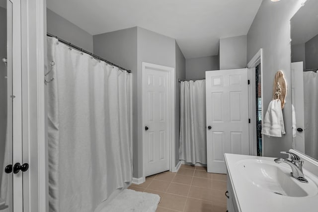 bathroom with tile patterned flooring, vanity, and curtained shower