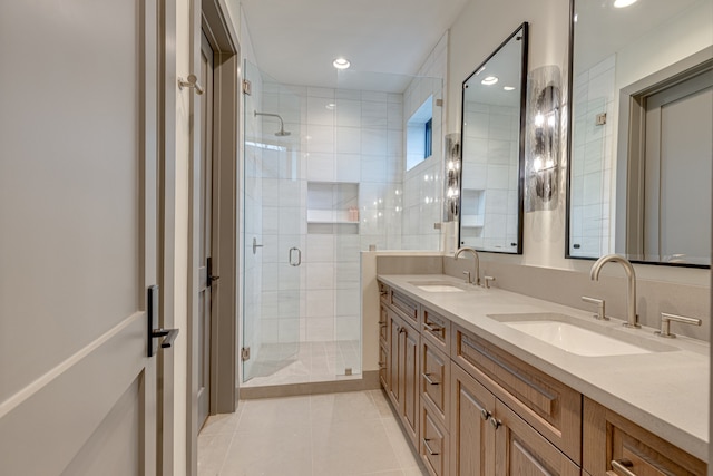 bathroom with tile patterned flooring, walk in shower, and vanity