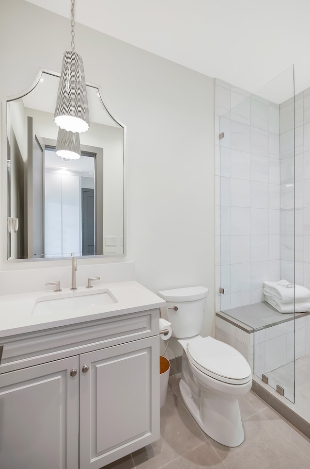 bathroom with vanity, toilet, and tile patterned floors