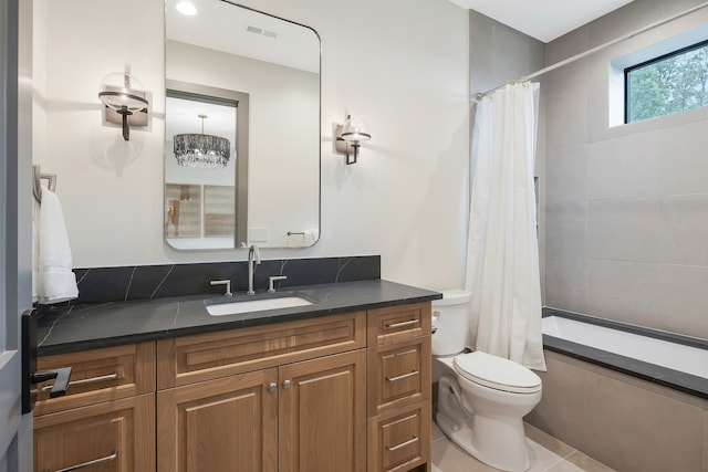 full bathroom featuring shower / bathtub combination with curtain, tile patterned floors, vanity, toilet, and a notable chandelier