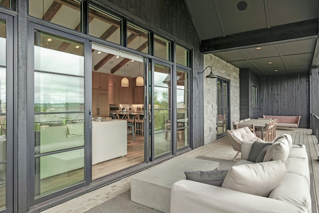 interior space with hardwood / wood-style floors, beam ceiling, and high vaulted ceiling