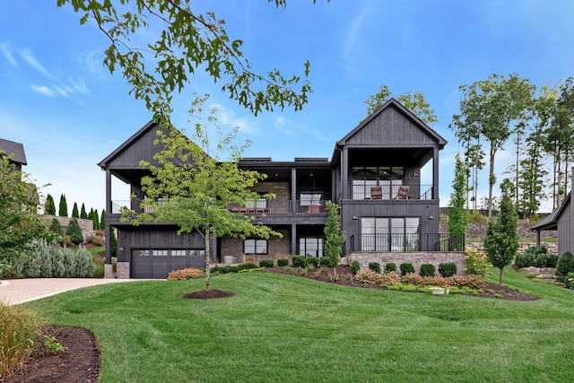 view of front of house featuring a balcony, a garage, and a front lawn