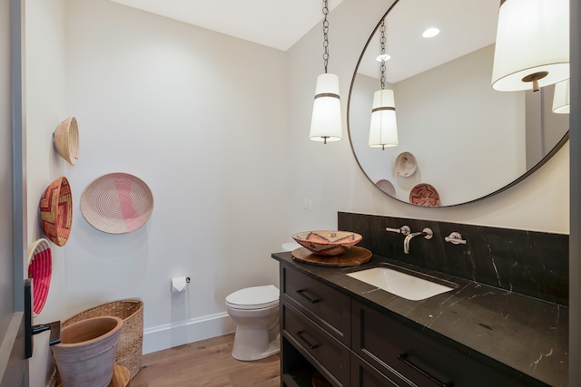 bathroom featuring hardwood / wood-style floors, vanity, and toilet