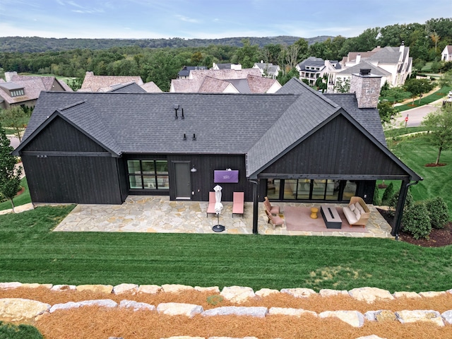 back of house featuring a yard and a patio area