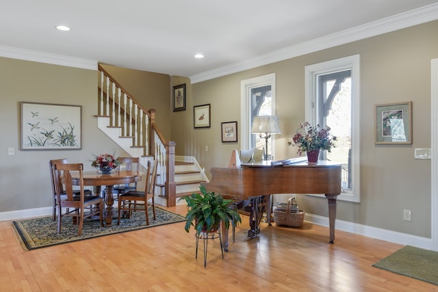 dining area featuring wood-type flooring and ornamental molding