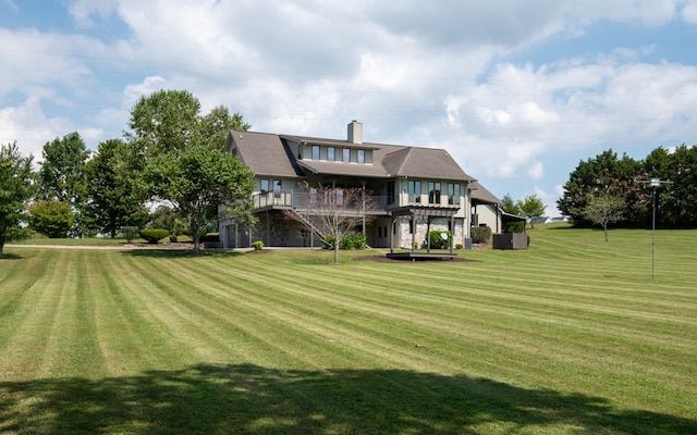 rear view of house with a lawn