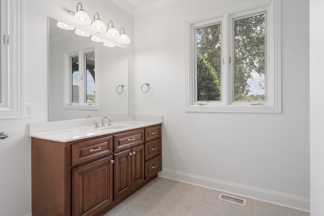 bathroom with vanity, ornamental molding, and tile patterned floors