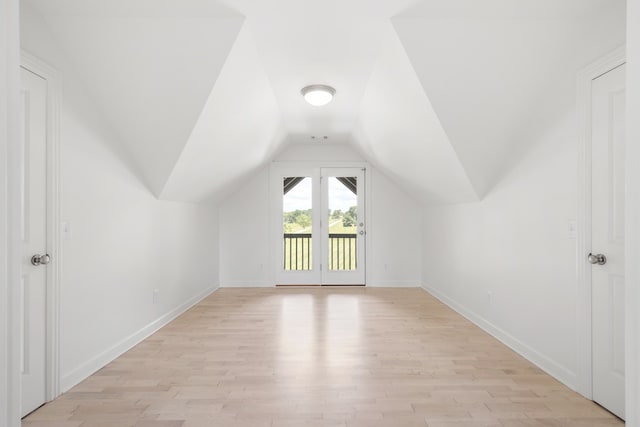 bonus room featuring vaulted ceiling and light hardwood / wood-style flooring