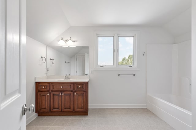 bathroom featuring lofted ceiling, tile patterned flooring, vanity, and shower / bathing tub combination