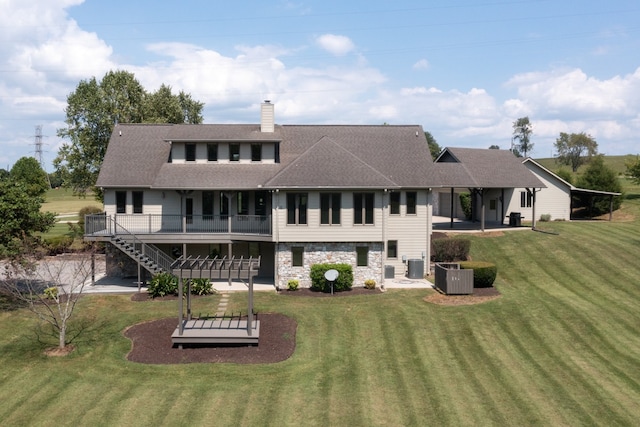 back of house featuring central air condition unit, a patio, and a yard