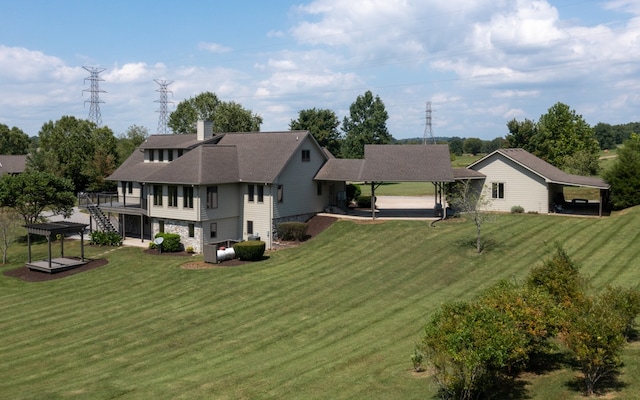 rear view of property featuring a lawn and a patio area