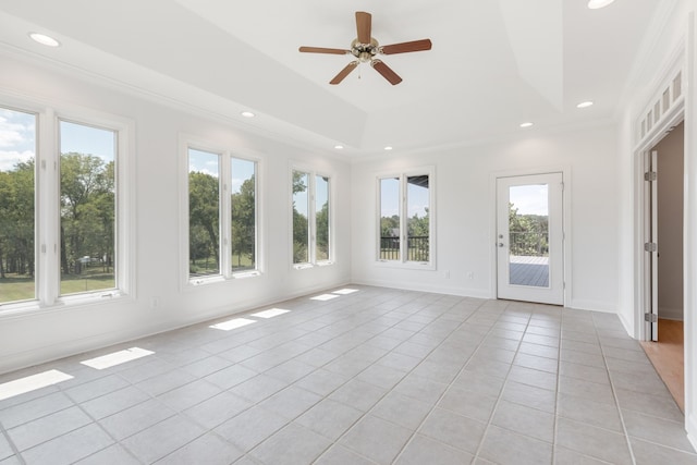 unfurnished sunroom featuring ceiling fan