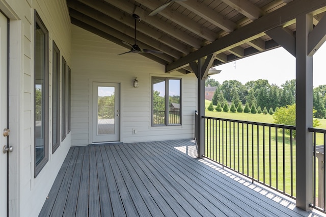 deck with a lawn and ceiling fan