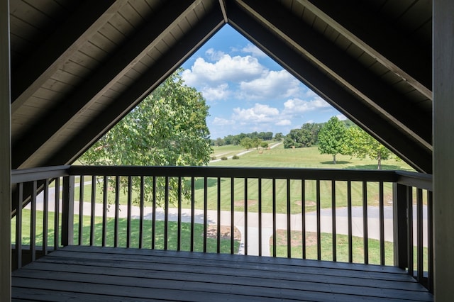 wooden deck featuring a lawn