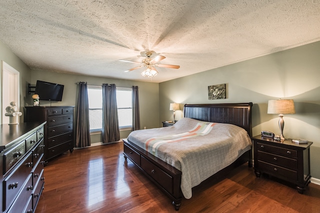 bedroom with a textured ceiling, dark hardwood / wood-style floors, and ceiling fan