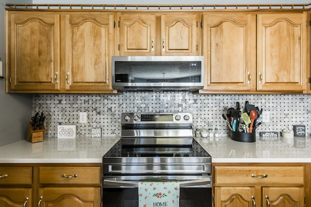 kitchen with appliances with stainless steel finishes and decorative backsplash