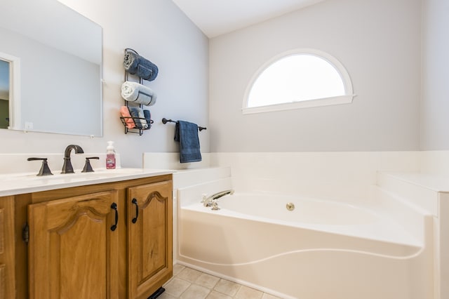 bathroom featuring tile patterned floors, a tub, and vanity