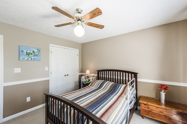 bedroom featuring ceiling fan, light colored carpet, and a closet