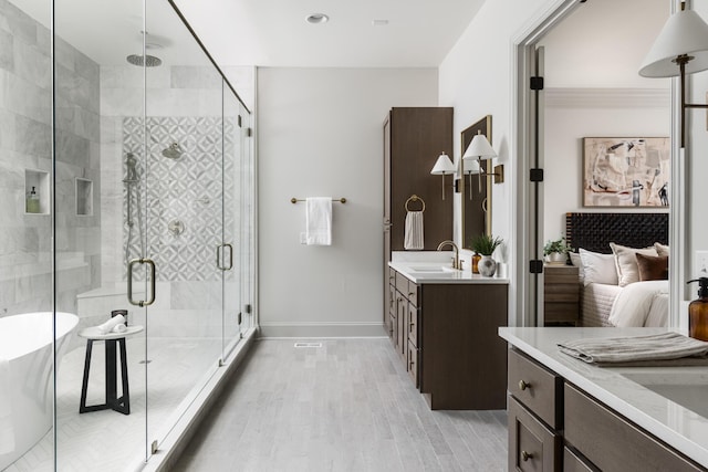 bathroom featuring vanity, shower with separate bathtub, and hardwood / wood-style flooring