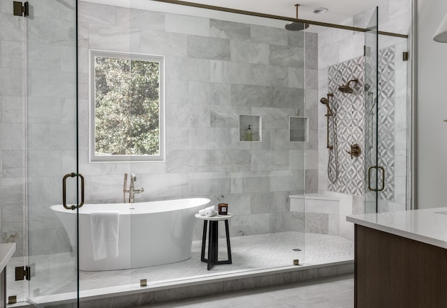 bathroom featuring separate shower and tub and tile walls