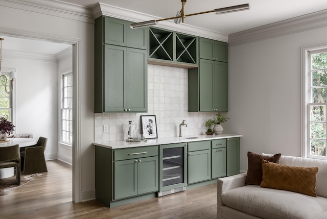 bar with hardwood / wood-style flooring, decorative backsplash, wine cooler, green cabinetry, and sink