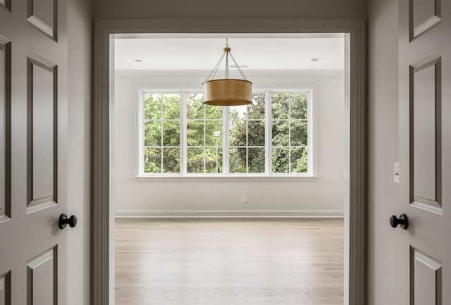 unfurnished room featuring a wealth of natural light and crown molding