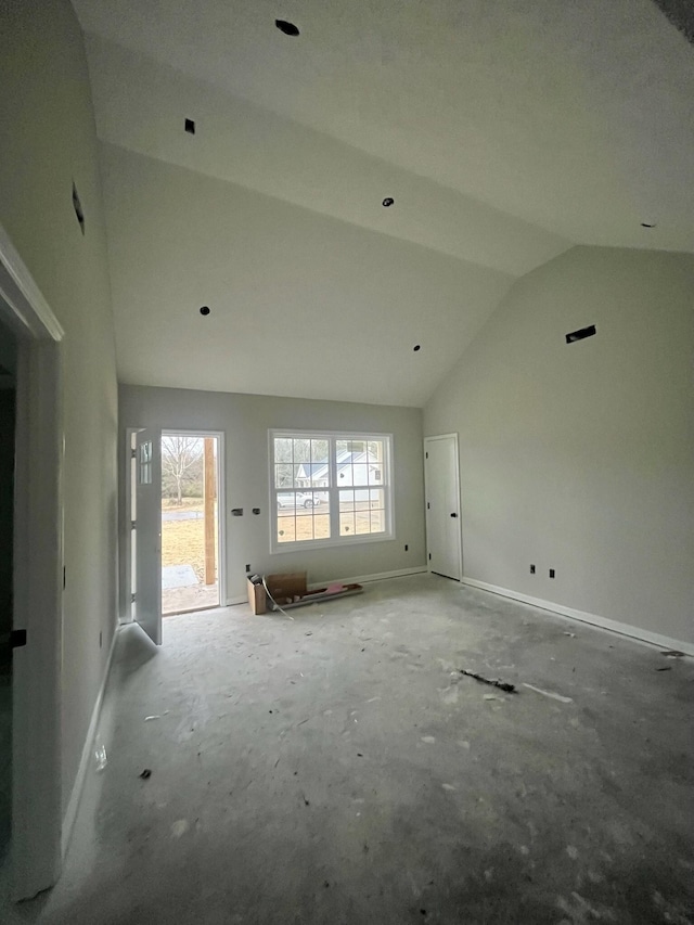 unfurnished living room featuring vaulted ceiling