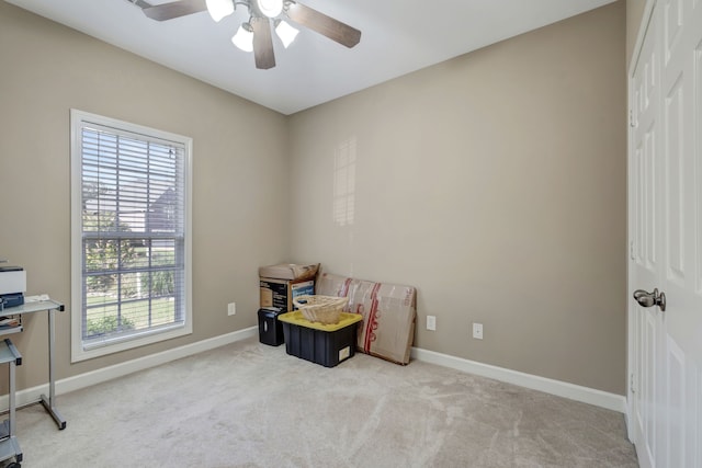 sitting room with ceiling fan and light carpet